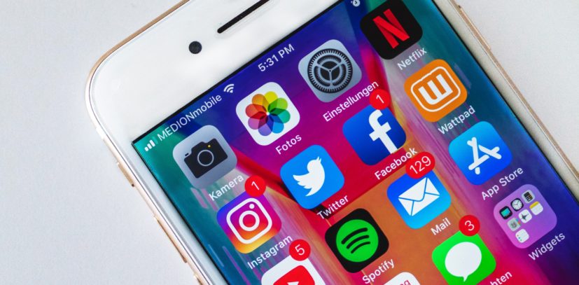 iPhone showcasing social media apps for social media policy