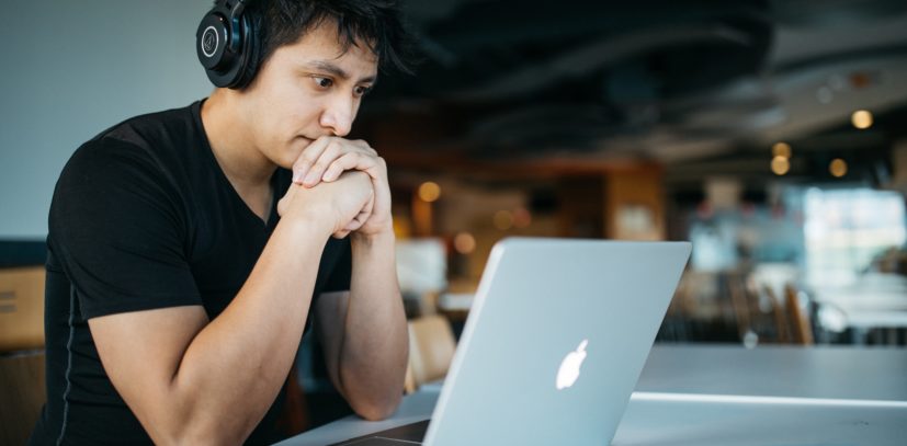 Young man anxiously working on project in spite of poor mental health